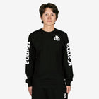 Person wearing a black long-sleeve shirt with Kappa logo on a white background