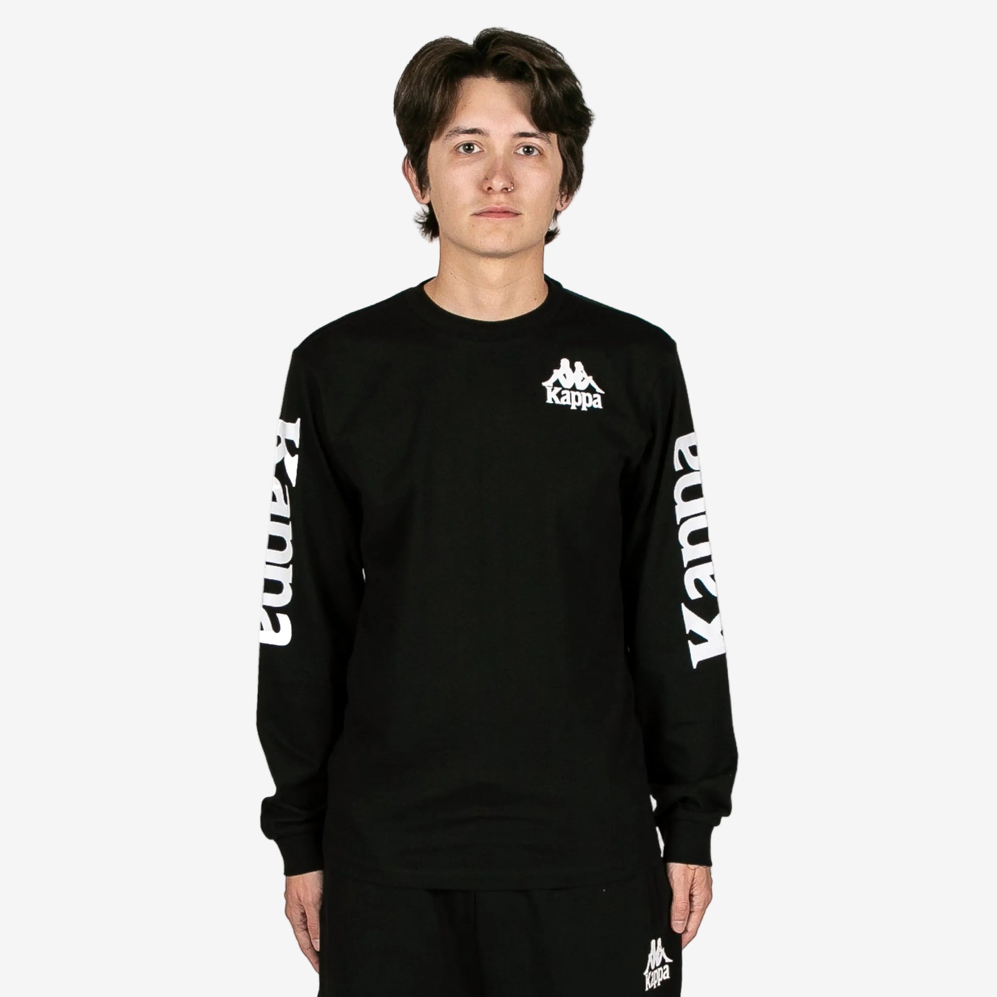 Person wearing a black long-sleeve shirt with Kappa logo on a white background