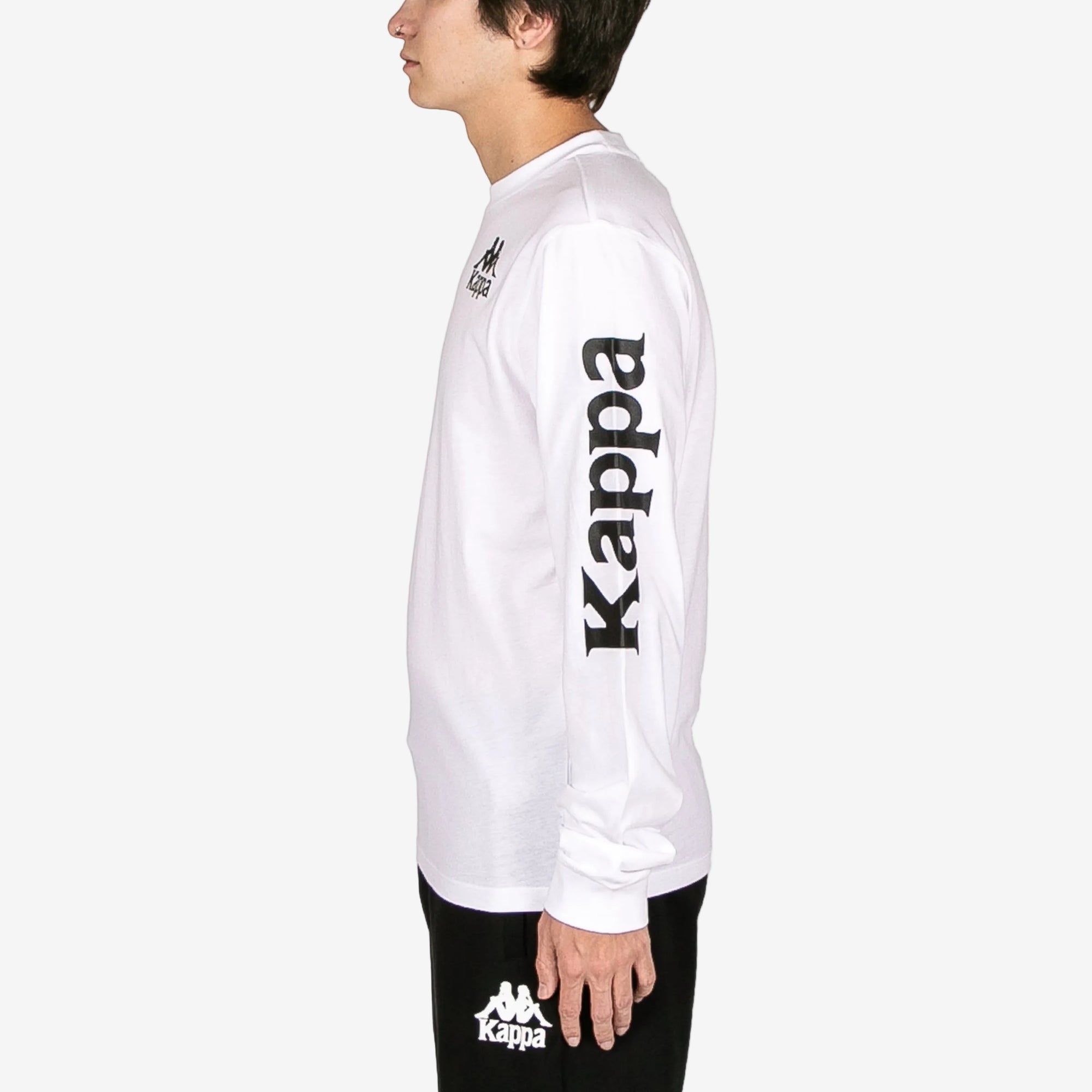 Person wearing a white long-sleeve shirt with Kappa branding on a white background