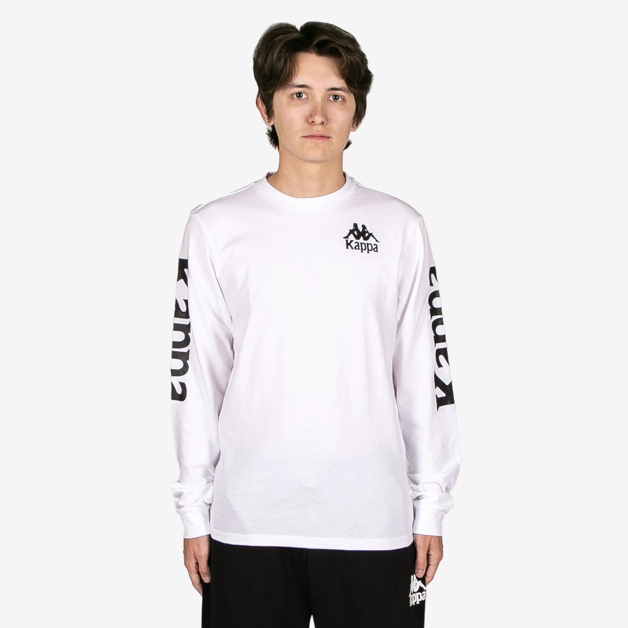 Person wearing a white long-sleeve shirt with Kappa logo on a white background
