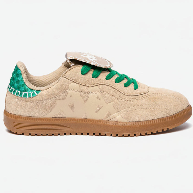 Beige sneaker with green accents on a white background