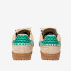 Pair of beige sneakers with green checkered pattern on a white background