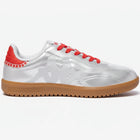 White sneaker with red laces and brown sole on a white background