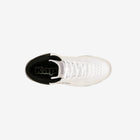 White sneaker with black sole on a white background