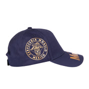 Modelo logo in gold on navy blue cap displaying the right side.