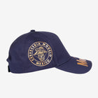 Modelo logo in gold on navy blue cap displaying the right side.