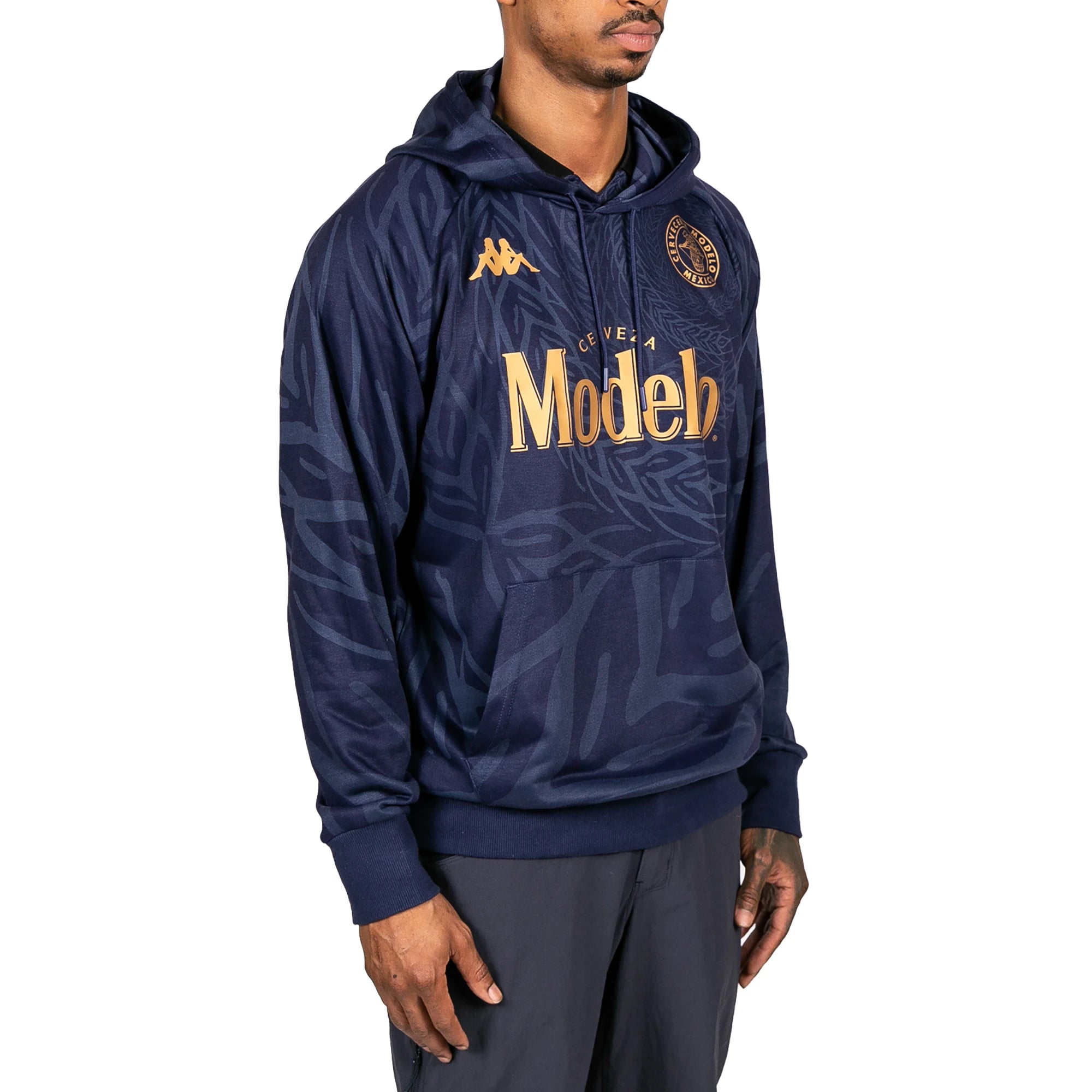 Male model wearing Ahop Modelo Hoodie in navy blue and gold. Side view.