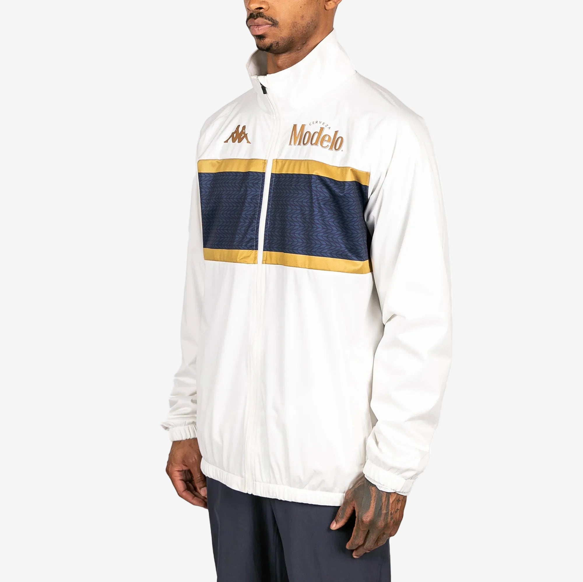 Male model wearing Arapi Modelo Jacket in white. Side view.