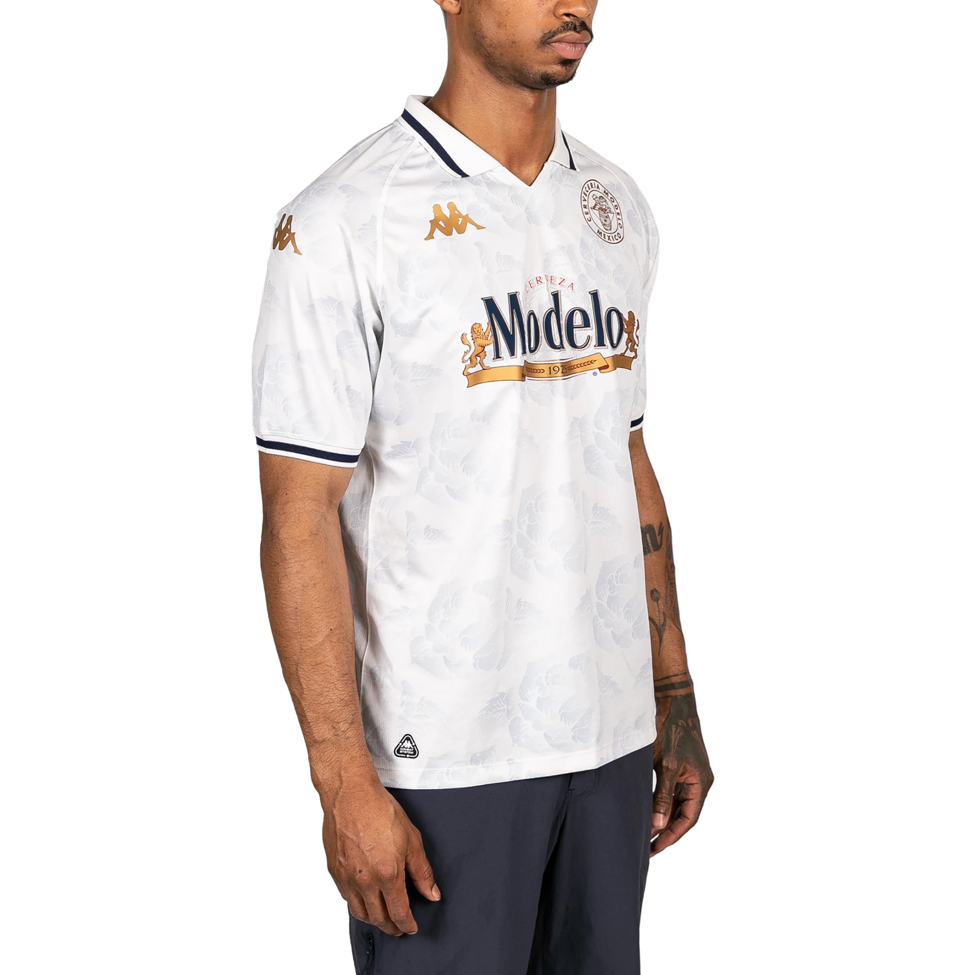 Male model wearing Kombat 2025 Modelo Soccer Jersey in white. Side view.