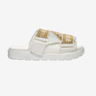 A white slide sandal with gold straps and a band featuring the Omini logo, set against a plain background.