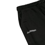 Detail view of Kappa lettering and Omini logo in white on black shorts.