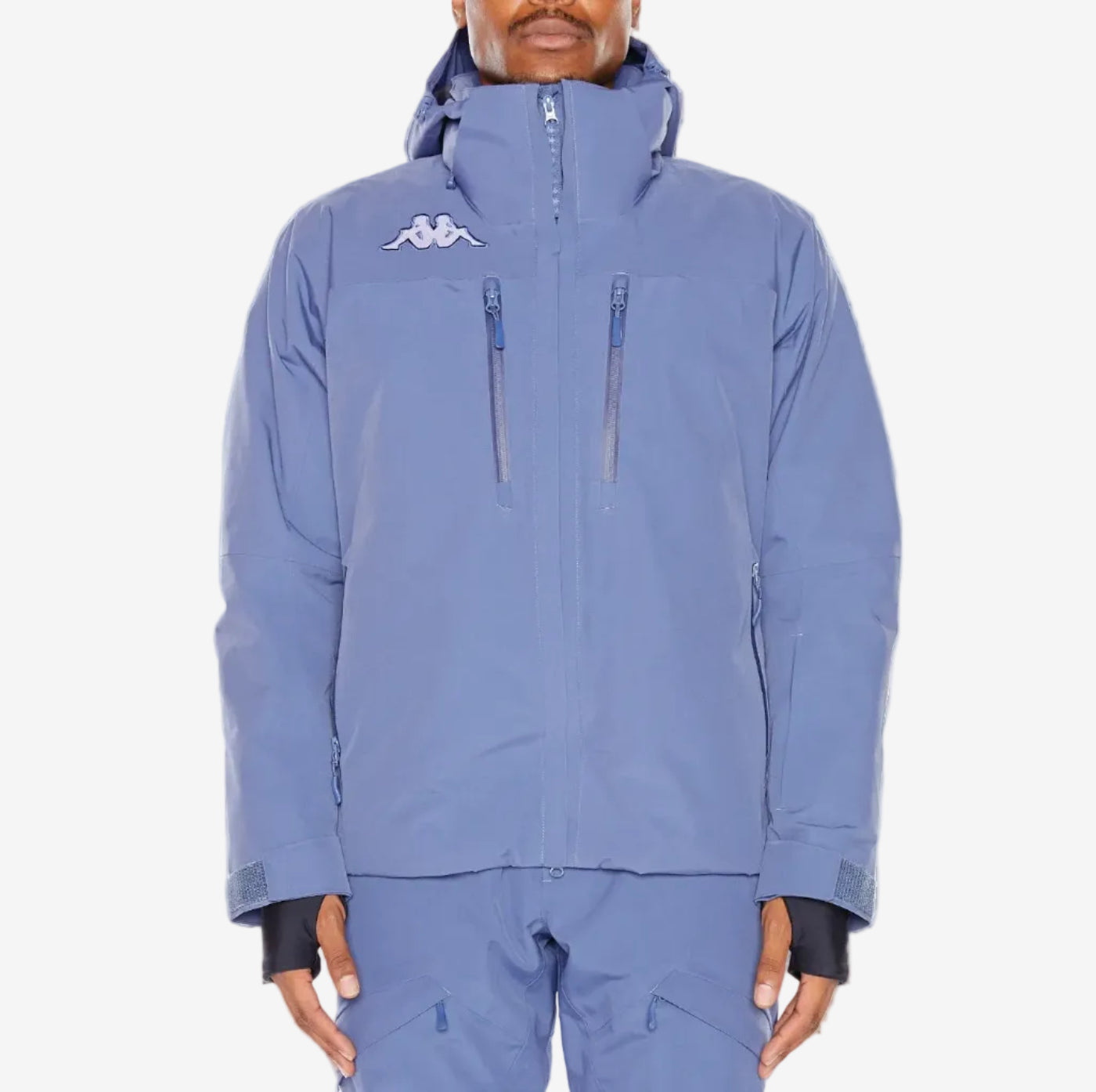 Person wearing a blue snowsuit with a brand logo on a white background